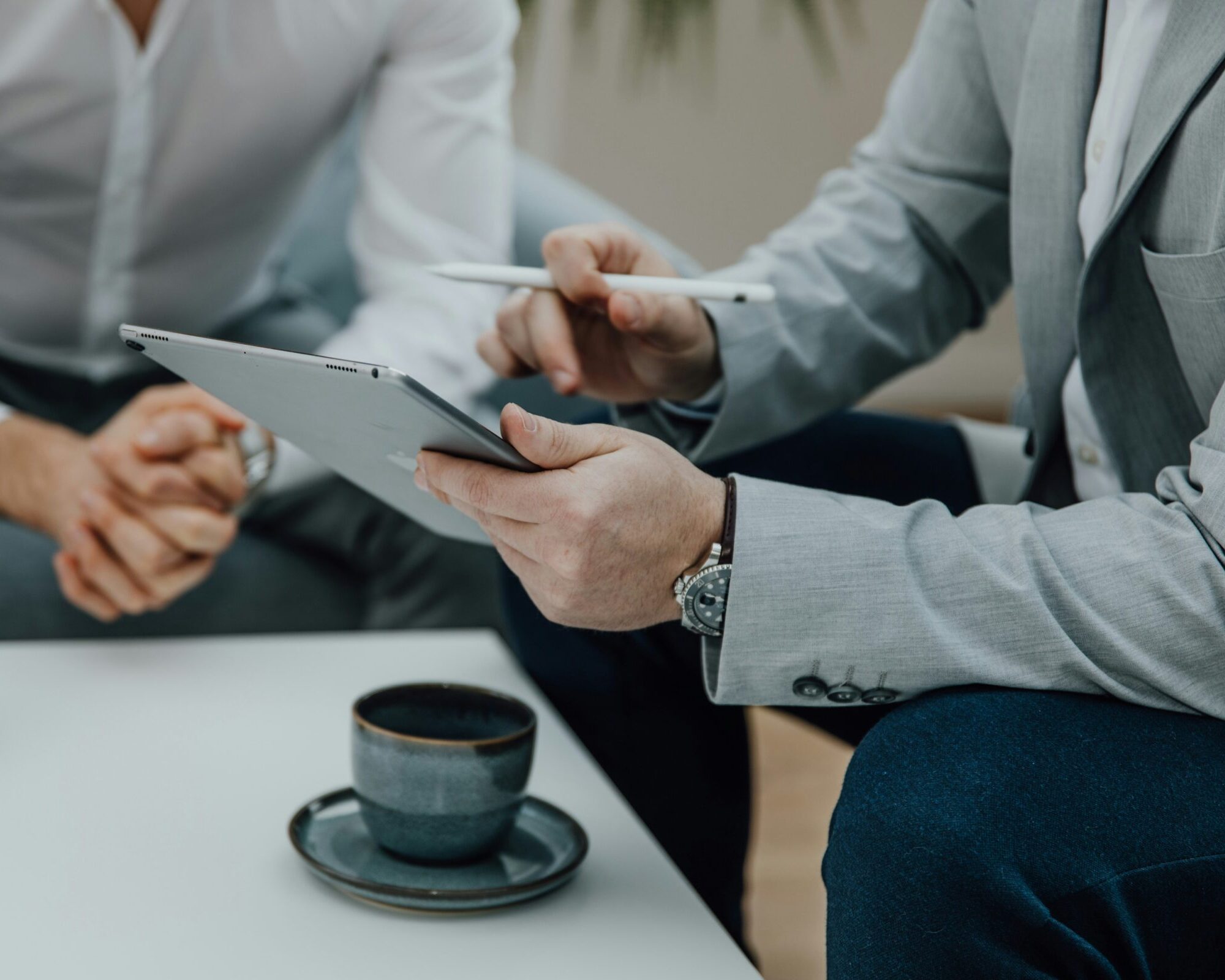 Two professionals reviewing geospatial project on a tablet — OnTerra Systems web mapping consulting and software development services